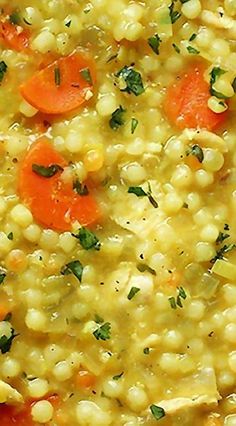 corn and carrots are mixed together in a bowl with herbs on the top, as well as parsley