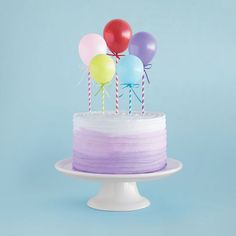 a birthday cake with balloons on top