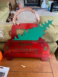 a christmas sign sitting on top of a wooden table next to a fire hydrant