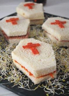 four pieces of cake with red crosses on them