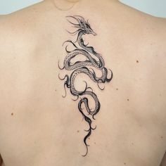 a woman with a dragon tattoo on her back