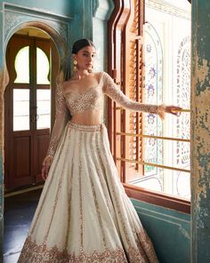 A stunning off-white lehenga with a gold embroidered blouse and skirt bottom.From Jigar & Nikita's Rang Mahal collection DELIVERY TIMEPlease allow 8-12 weeks for your outfit to arrive. FABRIC DETAILSHabutai silk Professional cleaning only. Luxury Traditional White Blouse Piece, White Gold Blouse, Gagra Choli Designs Latest, Contrast Lehenga, Off White Lehenga, Bridesmaids Outfits, Golden Lehenga, Wedding Fits, Sharara Designs