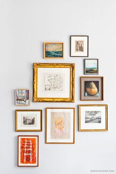 there are many pictures on the wall and one is framed with gold frames, while the other has an orange vase