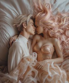 a man and woman laying on top of a bed next to each other with pink hair