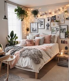 a bedroom decorated with plants and pictures on the wall