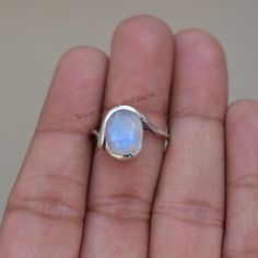 Gemstone-Rainbow Moonstone Shape-Oval Stone Size- 9X11 MM Metal-925 Sterling Silver This One of a kind ring is adorned with beautiful rich Rainbow Moonstone Gemstone set in sterling silver band. About gemstone- Rainbow moonstone is associated with various Moon Goddesses.Moonstone has a very strong connection to the spiritual world. It has great nurturing energy which will give ease and guide in difficult times especially in issues related to love and family. It helps in banishing our own negativ Unique Oval Moonstone Birthstone Ring, Oval Moonstone Ring With Natural Stones, Minimalist Oval Moonstone Ring With Natural Stones, Unique Untreated Oval Moonstone Ring, Untreated Oval Silver Moonstone Ring, Oval Moonstone Rings For Jewelry Making, Untreated Round Moonstone Ring, Handmade Oval Cabochon Moonstone Ring, Handmade Oval Moonstone Ring For Anniversary