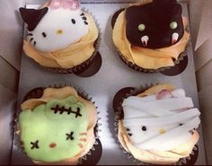 four decorated cupcakes in a box with hello kitty frosting