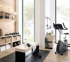 there is a gym with exercise equipment in the room and towels on the rack next to it