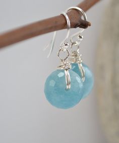 a pair of earrings hanging from a hook