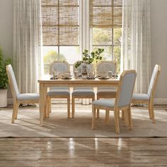 a dining room table with four chairs around it