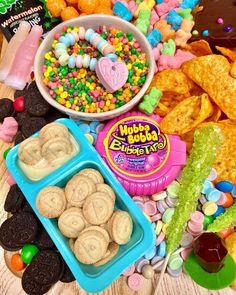 various snacks and candy on a wooden table