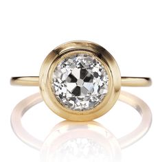 a gold ring with a white diamond in the center