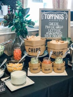 a table topped with lots of different types of dips and condiments next to a sign that says topings