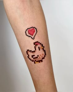 an arm with a pixelated chicken and heart on it