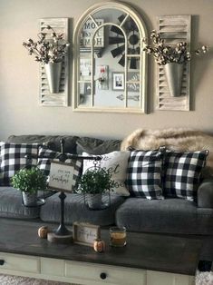 a living room filled with furniture and decor on top of a wooden table in front of a window