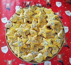 a platter filled with star shaped cookies on top of a table