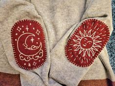 two sweaters with sun and moon designs on them