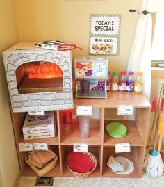 a toy oven sitting on top of a wooden shelf filled with toys and other items