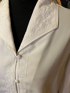 This is a rare gem and amazing condition. This is beautiful and clean and smoke-free. Measurements are approximately 21 inches  pit to pit flat 24 inches top to bottom. Thanks so much for looking. Have an amazing day. Long Sleeve Cream Blouse For Wedding, Embroidered Long Sleeve Formal Tops, Elegant Fitted Embroidered Shirt, Fitted Formal Shirt With Floral Embroidery, Embroidered Long Sleeve Tops For Formal Occasions, Cream Long Sleeve Shirt With Buttons, Formal Fitted Shirt With Floral Embroidery, Elegant Long Sleeve Embroidered Shirt, Classic Embroidered Collared Tops