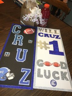 the table is set up with football themed signs and other items to decorate for sports fans