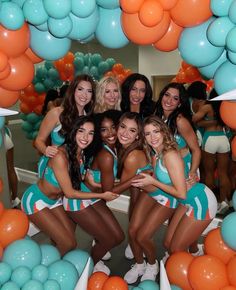 the cheerleaders are posing in front of balloons