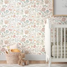 a baby's room with floral wallpaper and a crib