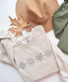 Aesthetic snowflake Christmas winter sweatshirt.  Graphic is made using direct to garment printing so you'll never have to worry about cracking or peeling images.  Available in Sand, White, Maroon, Forest Green, Pink, Black, & Ash Gray.  Gildan 18000 Unisex crewneck, fits true to size. Size up for an oversized fit.  - Made with a medium-heavy fabric blend of 50% cotton and 50% polyester - Fabric blends: Heather Sport colors - 60% polyester, 40% cotton Christmas Shirt Prints, Winter White Cotton Crew Neck Tops, Winter White Cotton Crew Neck Sweater, Crew Neck Sweatshirt For Winter Gift, Winter Holiday Cotton Sweatshirt, White Winter Sweatshirt For Gift, White Winter Sweatshirt Gift, White Winter Sweatshirt As A Gift, White Sweatshirt For Winter Gift