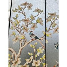 two panels with birds and flowers painted on them