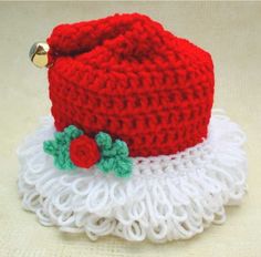 a red knitted hat on top of a white doily