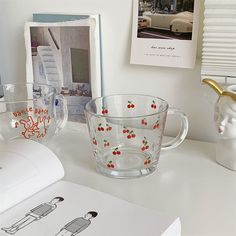 two glass cups sitting on top of a white desk