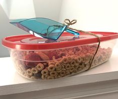 a plastic container filled with cereal sitting on top of a counter