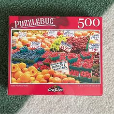 a jigsaw puzzle is laying on the floor next to some oranges and other fruit