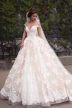 a woman in a wedding dress standing outside