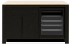 a black cabinet with an open door and drawers on the front, next to a white counter top