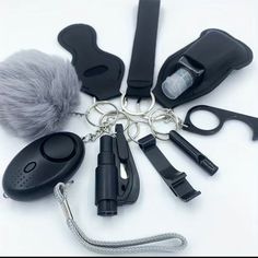 a bunch of different items that are on a white surface with one keychain