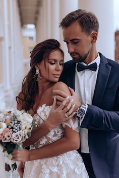 a man in a tuxedo and a woman in a wedding dress hugging each other