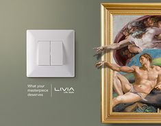 a painting on the wall next to a white light switch cover with an image of jesus and three graces