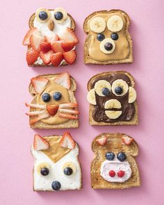 four slices of toast with fruit, peanut butter and other toppings on them are arranged in the shape of animals