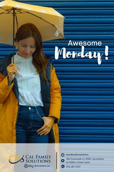 a woman holding an umbrella in front of a blue garage door with the words awesome monday written on it