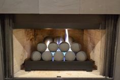 a fire place with some balls in it