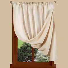 an open window with a curtain hanging on it's side and trees in the background