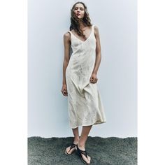 V-Neck Midi Dress With Wide Straps. Textured Fabric Detail. A-Line Silhouette. Elegant V-neck Sundress For Day Out, Beige V-neck Sleeveless Summer Dress, Beige V-neck Sleeveless Dress For Vacation, Viscose V-neck Midi Dress For The Beach, Beige V-neck Linen Dress For Beach, Cream V-neck Dress For Day Out, Beige V-neck Dress For Summer, Chic V-neck Viscose Dress For Summer, Beige V-neck Sundress For Day Out