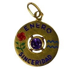 An 18 karat yellow gold charm pendant designed as a gold disc with enamel inlay of 'ENERO SINCERIDAD' (January Sincerity) with the zodiac symbol for Aquarius and a carnation (symbolising devotion, loyalty and love) in enamel, and set to the centre with a purple amethyst. Stamped with the owl mark for French import and 18 karat gold. Dimensions: 2 x 1.6 x 0.25 cm (not including jump ring) Weight: 1.40 grams Gold Disc, Antique Pendant, Aquarius Zodiac, Zodiac Symbols, Birthstone Charms, Gold Enamel, Pendant Design, Star Charms, Ruby Lane