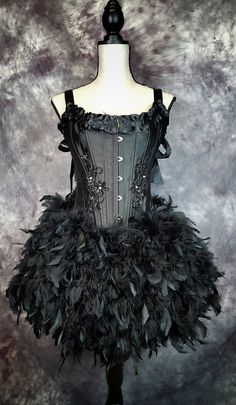 "INCLUDED IN LISTING: Feather corset costume (with black feathers all the way around) Please choose from the sizes below: Waist measurement is most important Corset available in the following sizes: Small Approximately: 32-34\" Bust, 24-25\" waist (Bra size 32A-32B) Medium Approximately: 34-36\" Bust, 26-27\" waist (Bra 32B-34B) Large Approximately: 36-38\" Bust, 27-29\" waist (Bra 34C-36C) XL Approximately: 38-40\" Bust, 30-32\" waist (36C/D) Waist measurement is most important *This corset run Black Overbust Corset Dress For Wedding, Black Overbust Costume For Party, Black Overbust Party Costume, Black Costume Dress For Carnival, Black Fantasy Overbust Corset, Fantasy Black Costume Corset, Halloween Corset Dress With Attached Cancan For Costume Party, Gothic Black Corset Dress With Attached Cancan, Black Corset Dress With Boned Bodice For Costume Party