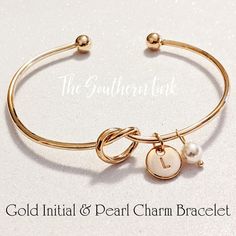 the gold initial and pearl charm bracelet is shown on a white background with text that reads,