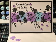 a birthday card with purple flowers on it and the words happy wishes written in black ink