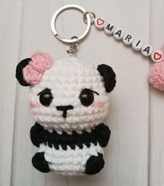 a crocheted panda keychain with the word mama written on it