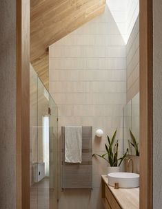 a bathroom with a sink, mirror and towel rack on the wall next to it