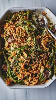 a casserole dish with green beans, mushrooms and other food items in it