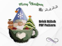 a cross stitch christmas card with santa in a cup